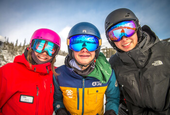 Lake Louise ski instructor providing instruction to two Academy participants.