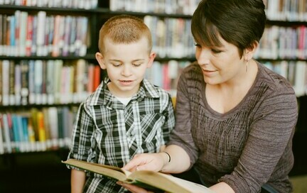 an educational assistant reading with a student